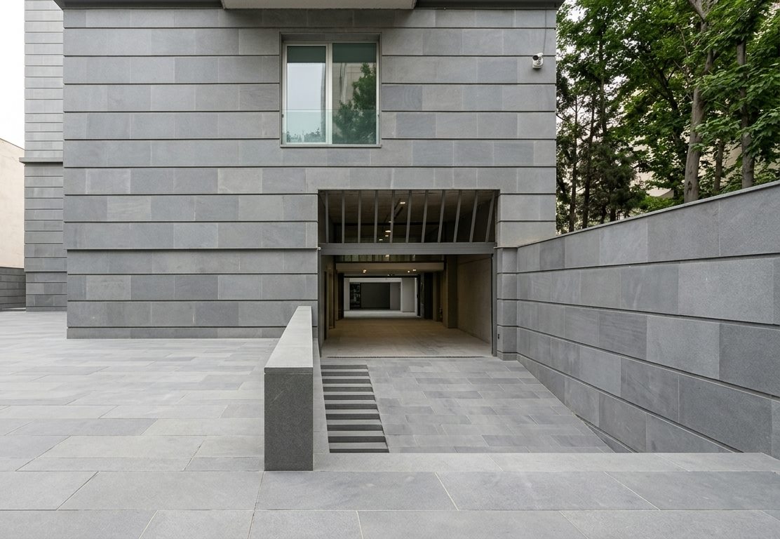 Public plaza with basalt wall cladding and large-format basalt paving