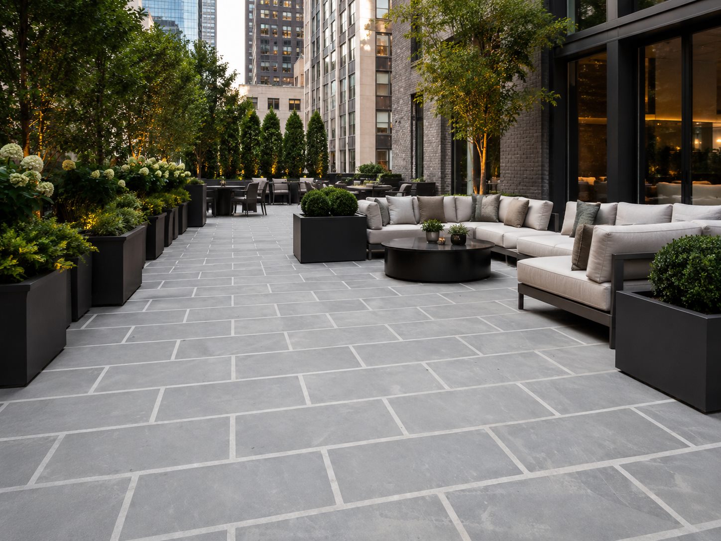 Roof terrace paved with large honed basalt slabs