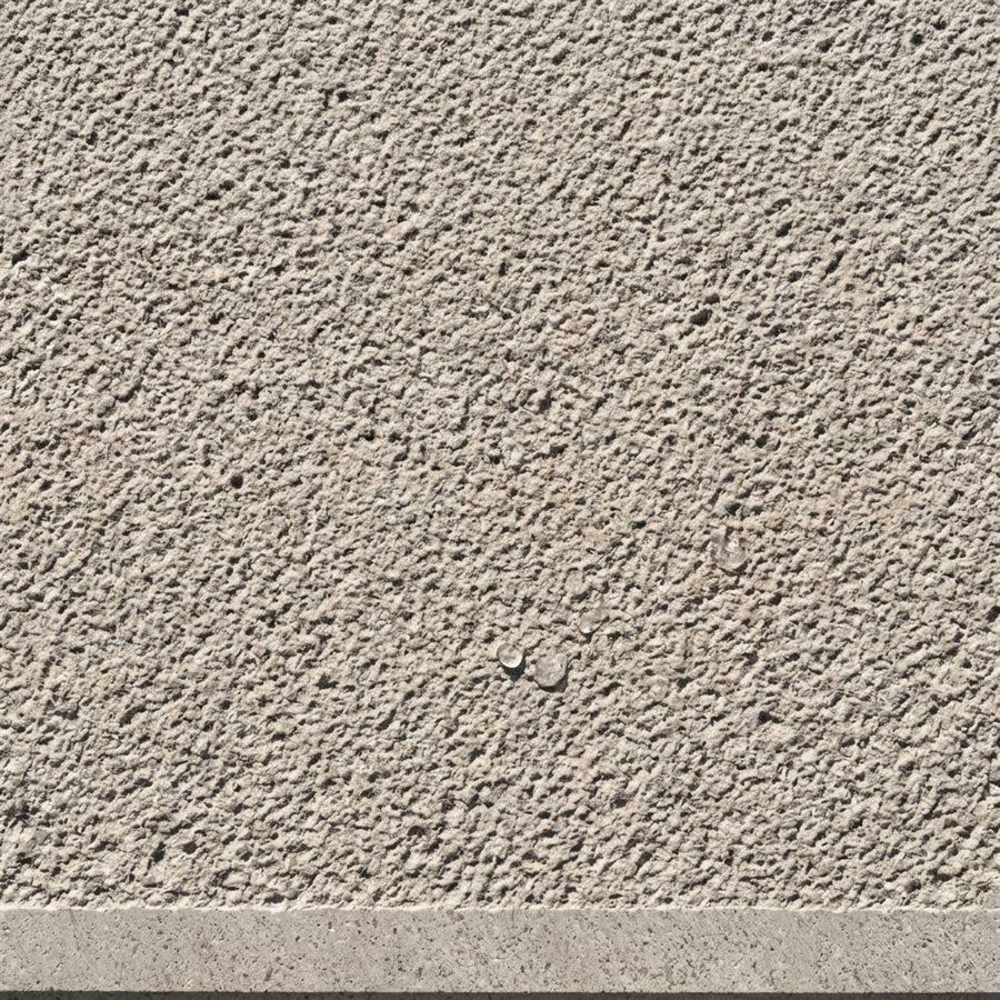 Close-up of antislip basalt with a fine textured surface and water beading on it