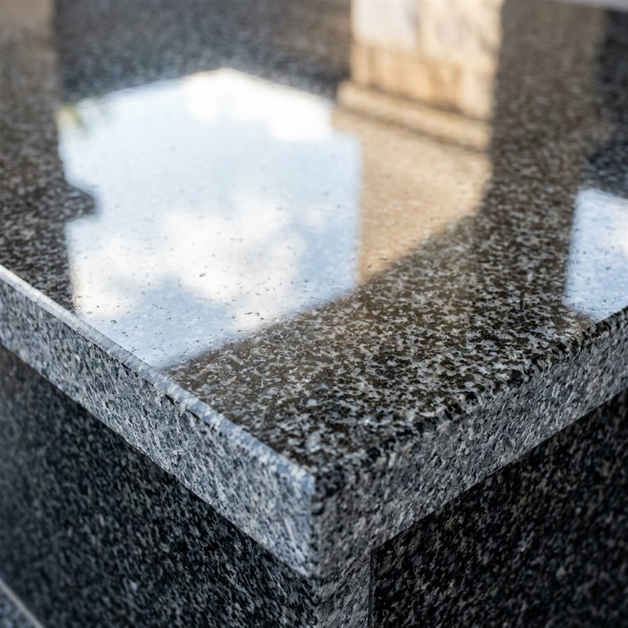 Close-up of polished Georgian granite with a mirror surface and worked edge